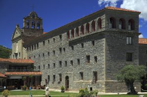 Fachada de piedra e iglesia del Hotel Monasterio de Boltaña, un antiguo monasterio reconvertido en hotel
